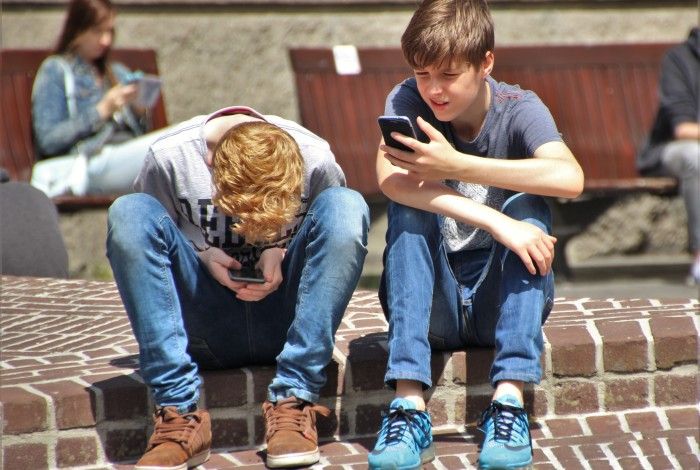 Two people using mobile phones